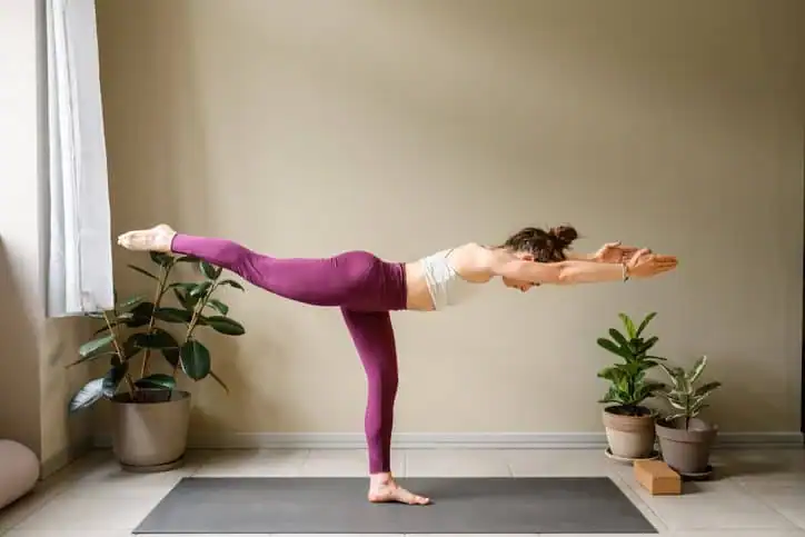 Woman doing Yoga exercise Farnham to help with toning the body. 
