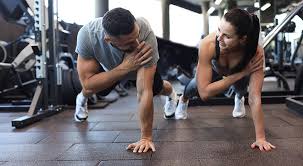 Image of man and woman doing Cardio Farnham to tone their arms. 